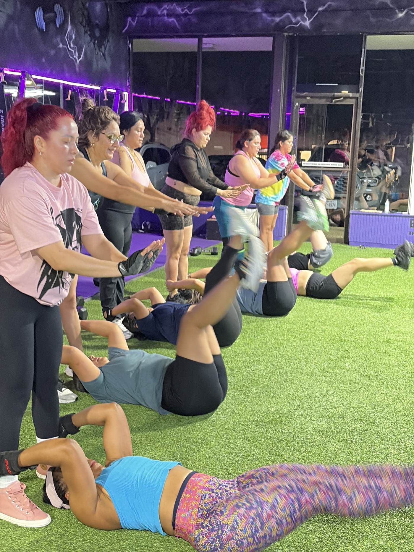 Members doing a partner exercise during an AMP class